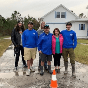 a group of people wearing deco products attire standing in front of a driveway