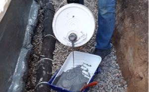 Deco Tac concrete in a bucket being poured into a tray